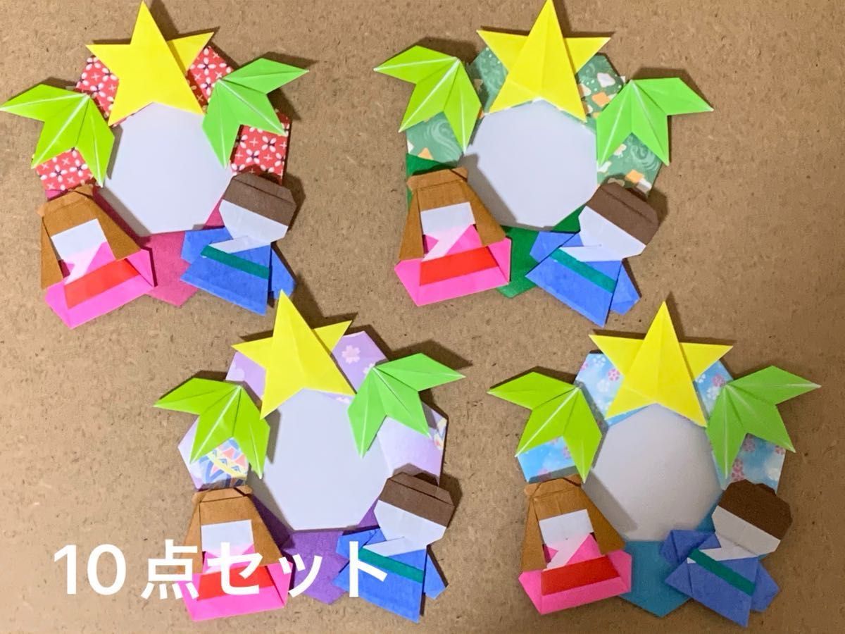 七夕リース . 2つ七夕のリース作ってみました🎋⭐️ 1枚目はカミキィさんの季節のおりがみより短冊を追加したものです❣️ もう1枚は月間おりがみの中から田中具子さんの笹の葉と竹、スイカ🍉と天の川は宮本真理子さんの本を参考にしています😊.origami ORIGAMI 介護