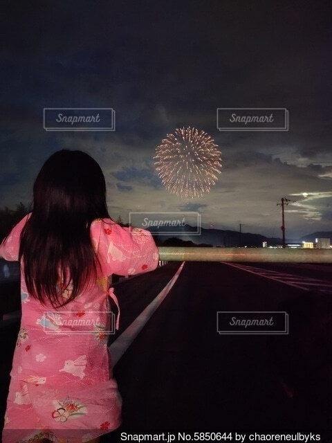 花火を見るカップルの後ろ姿の写真・画像素材-Snapmart スナップマート