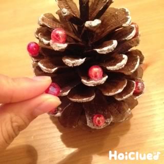 松ぼっくりで作る「ミニツリー」。松ぼっくりに色づけし、ビーズやフェルト玉を飾ってミニツリーを作りましょう。いくつか作って身近な人にプレゼントにするのもおすすめです。ペットボトルのふたの色味がかわいいクリスマス季節の制作松ぼっくり12月デイ